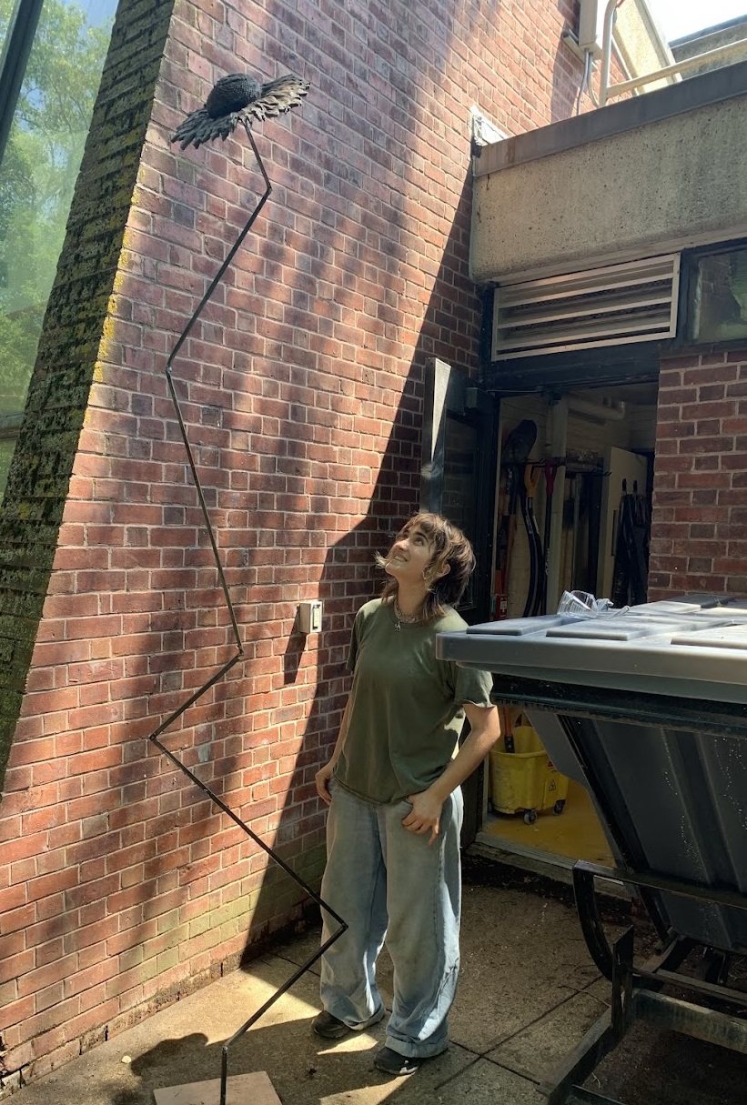 Me, looking up at a tall metal sunflower sculpture